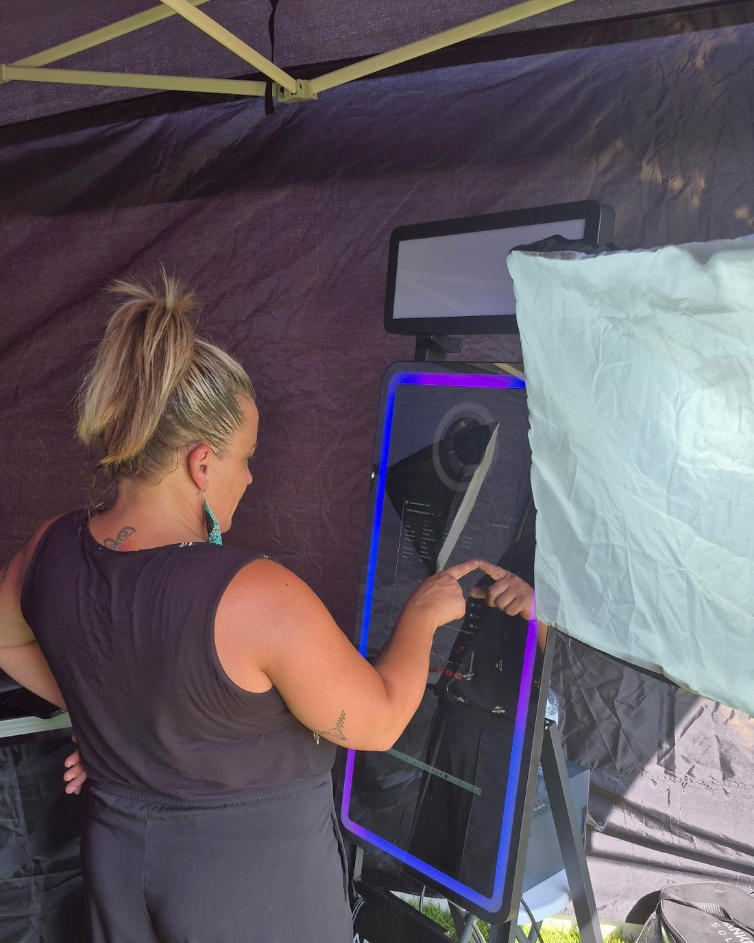 The Raven's Occasions mirror photo booth set up and attended at an outdoor event in Prince George